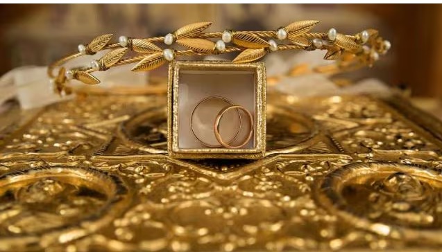 "Gold coins and bars representing 18, 22, and 24 carat gold prices in Indian cities